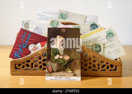 Birnen-Seife und Fry's Kakao-Werbepostkarten in einem Briefregal mit alten Stempeln. Stockfoto