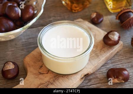 Hausgemachte Rosskastaniensalbe in einem Glas auf einem Holztisch Stockfoto