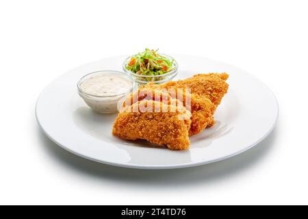 Gebratene Hähnchenkoteletts in Cornflakes, Gemüse, Dresssing Stockfoto