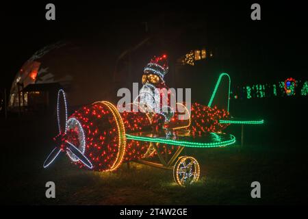 Weihnachtsstraßeninstallation strahlender Girlanden. Der Weihnachtsmann im Hubschrauber. Weihnachtliche Straßendekoration aus Girlanden im Dunkeln Stockfoto