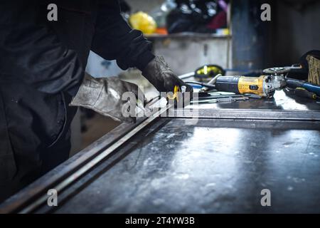 Mann, der Metallstab in der Industriehalle abmisst. In der Nähe von Kocani Mazedonien Stockfoto