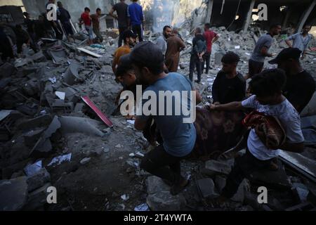 Menschen sickern durch den Schwelschutt von Gebäuden, die bei einem israelischen Streik auf das Flüchtlingslager Bureij zerstört wurden Menschen sickern durch den Schwelschutt von Gebäuden, die am 2. November 2023 bei einem israelischen Streik auf das Flüchtlingslager Bureij im zentralen Gazastreifen zerstört wurden. die Kämpfe zwischen Israel und der palästinensischen Hamas-Bewegung gehen weiter. Foto: Majdi Fathi apaimages Bureij Gazastreifen Palästinensische Gebiete 021123 Al-Breij MF 0012 Copyright: XapaimagesxMajdixFathixapaimagesx Stockfoto