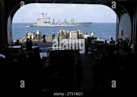 0702060318R-002 Gulf of Aden (6. Februar 2007) - Besatzungsmitglieder des amphibischen Angriffsschiffs USS Bataan (LHD 5) und Marines der 26. Marine Expeditionary Unit (MEU) bewegen Lagerhäuser und Fracht während einer vertikalen Auffüllung (VERTREP) mit dem Military Sealift Command Replenishment Oiler USNS John Lenthall (T-AO 189). Bataan befindet sich derzeit in einem geplanten Einsatz als Flaggschiff der Bataan Expeditionary Strike Group (ESG). US Navy Stockfoto