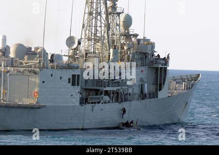 110721IO627-081 TIMOR-SEE (21. Juli 2011) Ein Matrose, der dem Raketenzerstörer USS Curtis Wilbur (DDG 54) zugeordnet ist, steigt während eines Besuchs, an Bord, Suche und Ergreifungsübung von einem aufblasbaren Starrrumpf zum Deck der Royal Australian Navy Adelaide-Klasse HMAS Darwin (FFG 04). Curtis Wilbur nimmt an Talisman Saber 2011 Teil, einer bilateralen Übung, die australische und US-Streitkräfte in der Planung und Durchführung kombinierter Task Force-Operationen ausbilden soll. Stockfoto