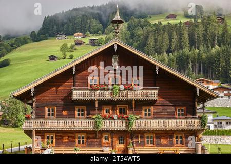 Traditional rustic wooden house decorated with flowers in Austria Stock Photo