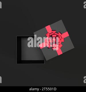 Draufsicht der offenen schwarzen Geschenkbox mit rotem Band und Schleife isoliert auf schwarzem Hintergrund und Kopierraum Stockfoto