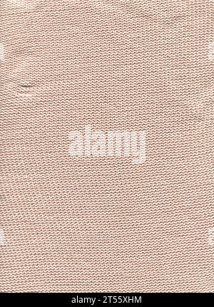 Skandinavisch beige gestrickt rustikalen Wolle Material Hintergrund. Warme, weizenfarbene, helle Strickqualität, flach liegend. Stockfoto