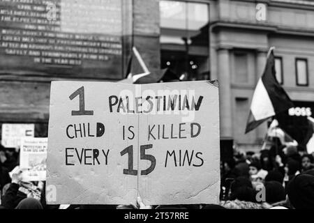 Newcastle upon Tyne, England, Großbritannien - 28. Oktober 2023 Demonstranten halten handgemachtes Schild: '1 palästinensisches Kind wird alle 15 Minuten getötet' am Grey's Monument. Stockfoto