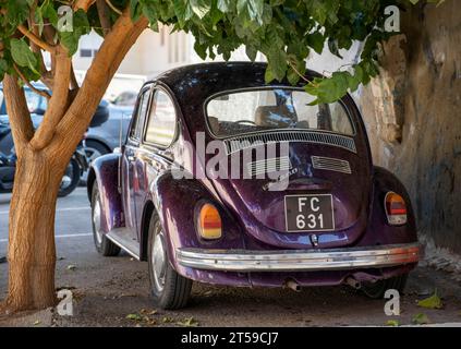 Der alte Volkswagen Käfer parkte unter einem Baum im Stadtzentrum von Larnaca, Zypern. Stockfoto