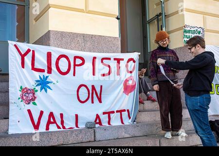 Yliopisto am Vallattu. Banner und Studenten vor der Universität Helsinki während eines Sitzungsprotests gegen Budgetkürzungen in Helsinki, Finnland. Stockfoto