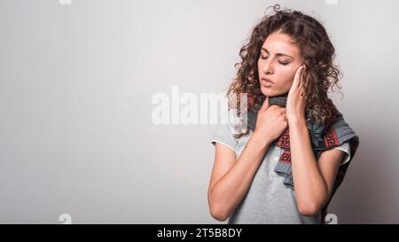 Kranke Frau mit Wolltuch um den Hals, die an Grippe leidet Stockfoto