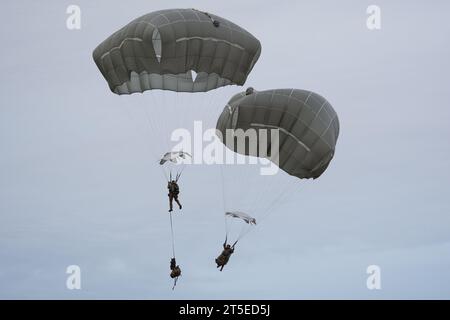 Fallschirmjäger der US-Armee mit dem 1. Bataillon, 501. Fallschirmjäger-Infanterieregiment, 2. Infanterie-Brigade-Kampfteam (Airborne), 11. Luftlandedivision, „Arctic Angels“, fallen ab, nachdem sie von der US-Luftwaffe C-17 Globemaster III, die dem 15. Flügel, der Joint Base Pearl-Hickam, Hawaii, zugewiesen wurde, gesprungen sind. und den 176. Flügel von der Joint Base Elmendorf-Richardson, Alaska, während er gemeinsame gewaltsame Einreiseoperationen in der Malemute Drop Zone, JBER, während der Arktis Aloha am 2. November 2023 durchführte. Arctic Aloha ist eine gemeinsame Übung der Armee und der Luftwaffe, die die Fallschirmjäger der 11. Luftlandedivision auf entscheidende Aktionen vorbereiten soll Stockfoto