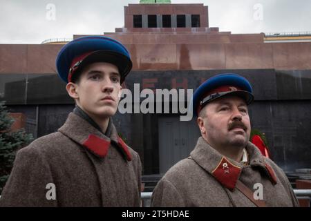 Moskau, Russland. 5. November 2023 Menschen in Uniform sowjetischer Soldaten und mit Waffen aus dem Beginn des Zweiten Weltkriegs stehen auf dem Roten Platz im Zentrum von Moskau vor dem Hintergrund des Lenin-Mausoleums und des Moskauer Kremls, Russland Stockfoto