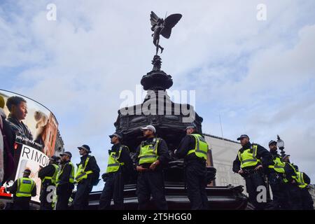 London, Großbritannien. November 2023. Polizeibeamte bewachen den Shaftesbury Memorial Fountain alias Eros im Piccadilly Circus. Eine Gruppe von Demonstranten marschierte im Zentrum Londons und schloss sich Zehntausenden von Menschen zu einer Kundgebung auf dem Trafalgar Square an, die einen Waffenstillstand forderte und in Solidarität mit Palästina angesichts des zunehmenden israelisch-Hamas-Krieges forderte. Stockfoto