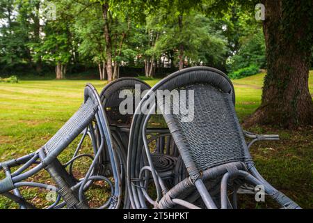 Vier Stühle gruppieren sich um einen Tisch unter einem Baum in einem Park, St. Georges Kloster Isny im Allgäu, Baden-Württemberg, Deutschland. Stockfoto