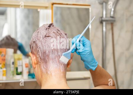 Moskau, Russland - 16. Oktober 2023: Frau färbt ihre Haare zu Hause. Frau, die Haarfarbe auf den Kopf aufträgt. Hochwertige Fotos Stockfoto