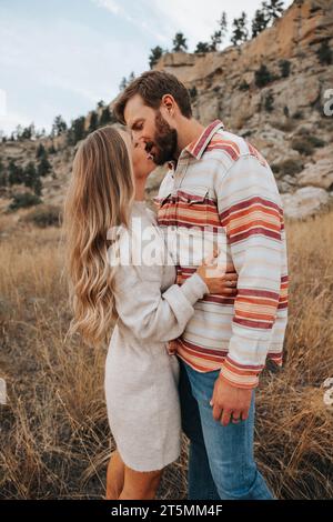Mom und Dad teilen einen romantischen Kuss in der Natur Stockfoto