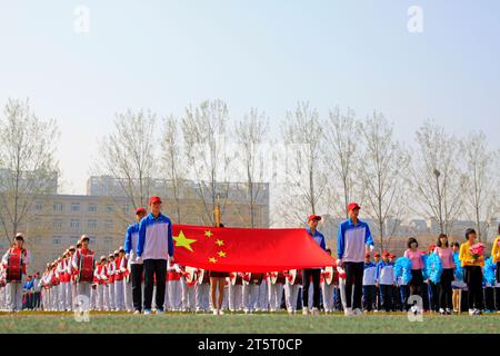 LUANNAN COUNTY - 14. APRIL: China-Flagge und Fahnenträger beim Leichtathletik-Treffen, 14. April 2015, Luannan County, Provinz Hebei, China Stockfoto