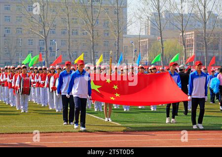 LUANNAN COUNTY - 14. APRIL: China-Flagge und Fahnenträger beim Leichtathletik-Treffen, 14. April 2015, Luannan County, Provinz Hebei, China Stockfoto