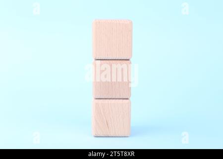 Internationale Organisation für Normung. Holzwürfel mit der Abkürzung ISO auf hellblauem Hintergrund Stockfoto