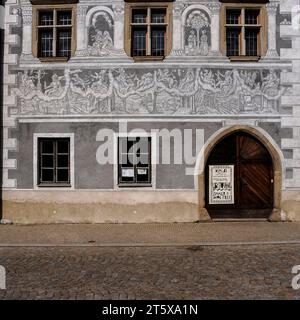 Sgraffito an der Renaissancefassade des Bürgermeisters oder Stadthauses am Horni náměstí (Oberer Platz) in Slawonice, Südböhmen, Tschechien. Die Sgraffito-Entwürfe auf diesem Anwesen, Horni náměstí 517, beinhalten: Joab, der Amasa tötet; Lied von Salomo; und sieben planetarische Gottheiten, die in Wagen über den Himmel fahren (Venus und Cupid, Jupiter, Mars, Luna, Sol, Saturn und Quecksilber), über den Szenen des Lebens auf der Erde. Stockfoto