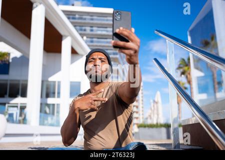Ernster Schwarzer macht ein Selbstfoto mit einem Smartphone. Stockfoto