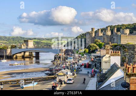 29. September 2023: Conwy, Nordwales - die Uferpromenade, die Burg und zwei Brücken an einem schönen Herbstnachmittag. Stockfoto