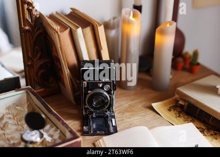 Retro-Kamera, Bücher auf Holztisch, Konzept der Genealogie, Erinnerung an Vorfahren, Stockfoto