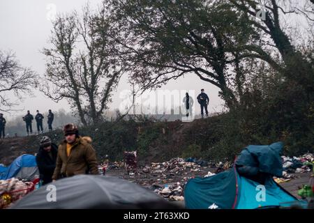 Michael Bunel/Le Pictorium - November 2016, Evakuierung des Calais'Dschungels - 15/01/2021 - France/Haut de France/Grande Synthe - Forces de l'ordre sperren die Lagerzugänge ab, da Flüchtlinge auf die Evakuierung warten. Die von der Präfektur gemieteten Busse sollen die Exilanten zu den Empfangszentren bringen. Nach Angaben der Verbände vor Ort (HRO und Utopia 56) hatten die Menschen zwei Möglichkeiten: In den Bus steigen oder sich mit der PAF (Grenzpolizei) befassen müssen. November 2021. Grande Synthe. Im November 2016 wurde der „Dschungel“ von Calais, dem größten Sluttenviertel Europas, evakuiert. Fünf Jahre später sind die Exilanten weiter Stockfoto