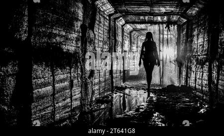 Silhouette eines jungen schlanken Mädchens in einem Sturmabflussschacht Stockfoto
