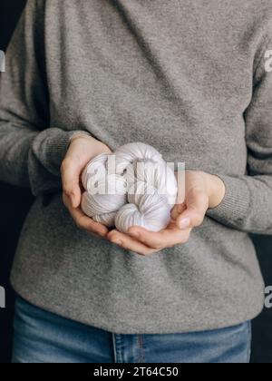 Weibliche Hände mit Garnknäuel zum Stricken. Selektiver Fokus. Stockfoto