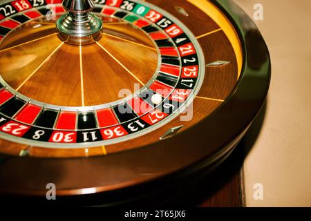 Roulette im Casino auf beigefarbenem Hintergrund, der Ball fiel auf sechs schwarz. Hintergrund für das Gaming-Geschäft. Gewinner, Spaß, Reichtum Konzept. Stockfoto