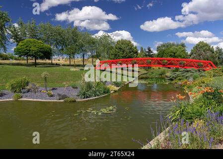 Vandœuvre-lès-Nancy, Frankreich - im Richard-Pouille-Park steht eine rote Brücke über einen Fluss. Stockfoto