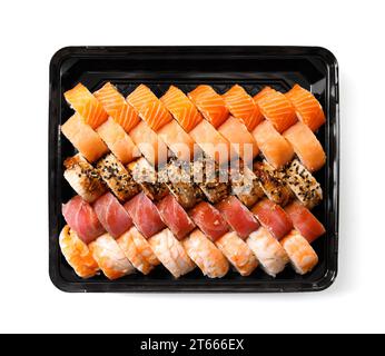 Ein großer Satz Sushi-Brötchen mit Garnelen, Lachs, Thunfisch, Aal in Plastikverpackung auf weißem Hintergrund, Draufsicht. Sushi-Lieferung. Stockfoto