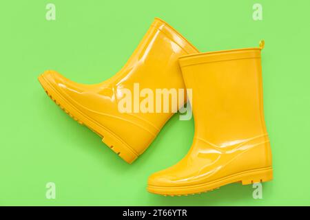 Yellow gumboots on green background Stock Photo