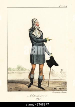 Modischer junger Mann oder Incrovable, Directoire-Ära, 1796. In zweireihigem Mantel, hohem Kragen, Weste, Reithose, wadenlangen Stiefeln, einen Hut und Knüppel halten. Kostüm d'un Jeune Heim, 1796. Handkolorierte Lithographie von Lorenzo Bianchi und Domenico Cuciniello nach Hippolyte Lecomte aus Costumi civili e militari della monarchia francese dal 1200 al 1820, Neapel, 1825. Italienische Ausgabe der Lecomtes Zivil- und Militärkostüme der französischen Monarchie von 1200 bis 1820. Stockfoto