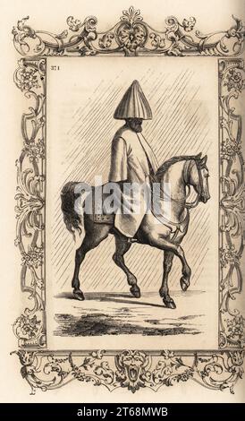 Ein türkischer Mann, ein Pferd im Regen zu reiten, 16. Jahrhundert. Er trägt eine Art Kapuze, die sich wie ein Regenschirm über seinem Turban öffnet. Und einen schweren Filzmantel über seinen Klamotten. Maniere don t les Turcs ist ein mittelalterliches Quand il pleut. In einem dekorativen Rahmen von H. Catenacci und Fellmann. Holzschnitt von Gerard Seguin und E.F. Huyot nach einem Holzschnitt von Christoph Krieger aus Cesare Vecellios Kostüme Anciens et Modern, Habiti antichi et moderni di tutto il mondo, Firman Didot Ferris Fils, Paris, 1859-1860. Stockfoto