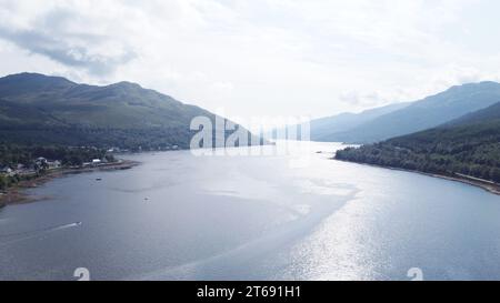 Ein ruhiger Blick auf die Landschaft mit einem See, eingebettet zwischen majestätischen Berggipfeln, gesehen in einem bewölkten Himmel Stockfoto