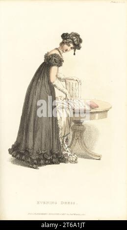 Regency-Dame im Abendkleid liest eine Musical-Partitur. Rundes Kleid mit schwarzem Kragen über Sarknet-Slip, einzelner Volant mit Bugles, tief geschnittenes Mieder mit tucker, schwarze Haube mit Bugles. Entworfen von Miss Pierpoint, 9 Henrietta Street, Covent Garden. Band 9, Platte 17, 1. März 1820. Handkolorierter Kupferstich von Thomas Uwins aus Rudolph Ackermanns Repository of Arts, Strand, London. Stockfoto