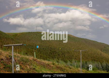 regenbogen über den Bergen an einem Herbsttag bei Sonnenuntergang Stockfoto