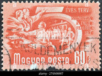 Von Ungarn gedruckte gestempelte Briefmarke, die die Zusammenarbeit in der Landwirtschaft zeigt, Fünfjahresplan, um 1950. Stockfoto