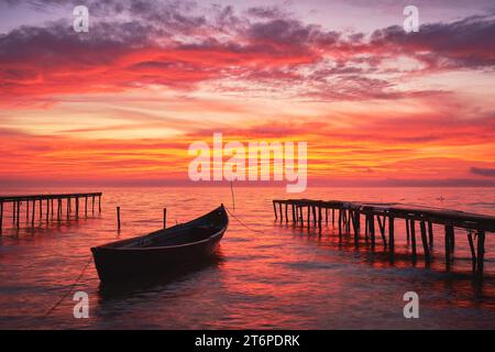 Boot bei Sonnenaufgang auf dem See Stockfoto