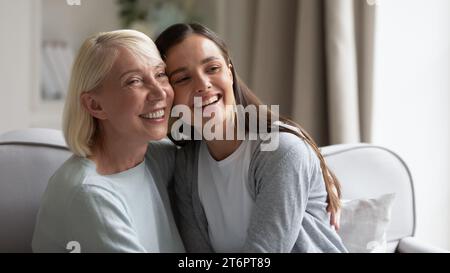Glückliche, reife Großmutter und Enkelin, die sich umarmen, Spaß haben Stockfoto
