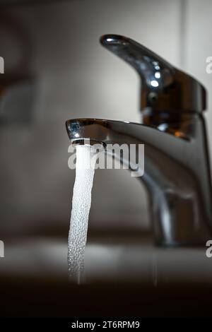 PRODUKTION - 10. November 2023, Baden-Württemberg, Ravensburg: Trinkwasser fließt aus einem Wasserhahn. Motiv von der Seite (zu dpa: "Verbraucher müssen steigende Trinkwasserpreise erwarten") Foto: Felix Kästle/dpa Stockfoto