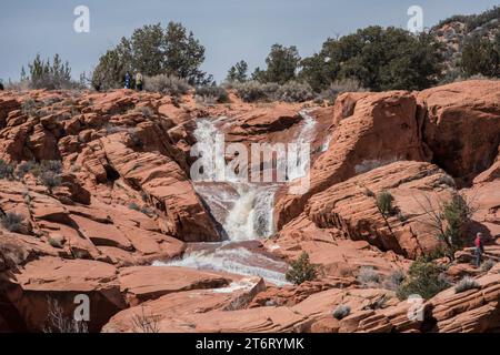 Der Überlauf des Gunzelreservoirs, ein ungewöhnliches Ereignis, das im Frühjahr 2023 zu Wasserfällen in den navajo Sandsteinklippen in Ivins, Utah, führte Stockfoto