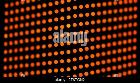 Orange abstrakte Grunge Raster Polka Punkt Halbton Hintergrundmuster, LED Bildschirm Anzeige. Gepunktete schwarze und orangefarbene Strichgrafik, Texturen. Stockfoto