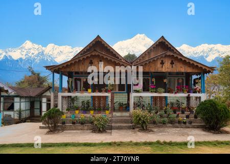Wunderschöne Holzhäuser mit Kanchenjunga Himalaya Gebirgszug im Hintergrund bei Tinchuley, Darjeeling, Indien. Stockfoto