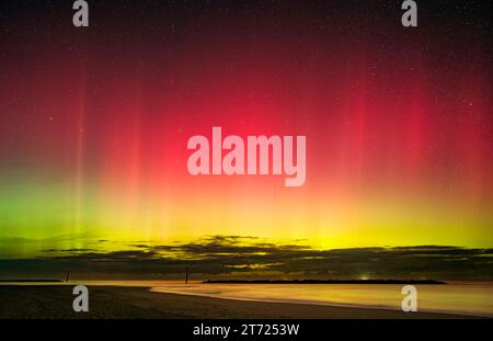 Die Aurora Borealis tanzt über dem Meeresstrand in Norfolk Stockfoto