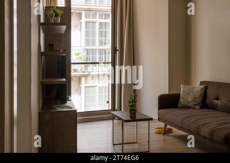 Inneneinrichtung eines gemütlichen Wohnzimmers mit stilvollem Sofa, Couchtisch, Blumen und Dekorationen Stockfoto