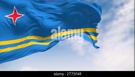 Die Flagge von Aruba winkt im Wind an klaren Tagen. Hellblaues Feld, 2 gelbe Streifen, 4 roter Stern. Farben stehen für Meer, Fülle, Frieden und o Stockfoto